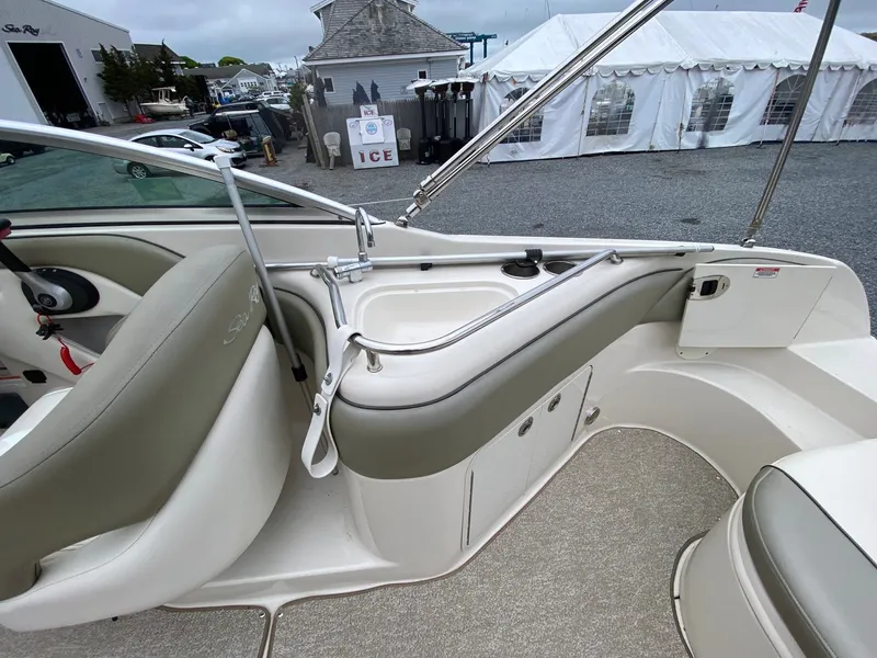 Slide: The Image of Interior of a 2006 Sea Ray 240 Sundeck boat with seating area. - 12
