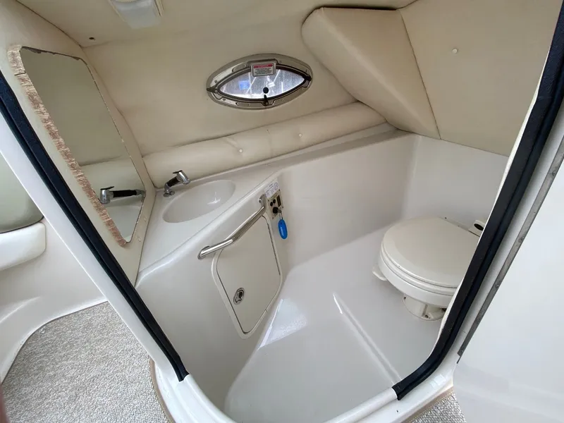 Slide: The Image of Interior of 2006 Sea Ray 240 Sundeck with toilet and sink. - 13