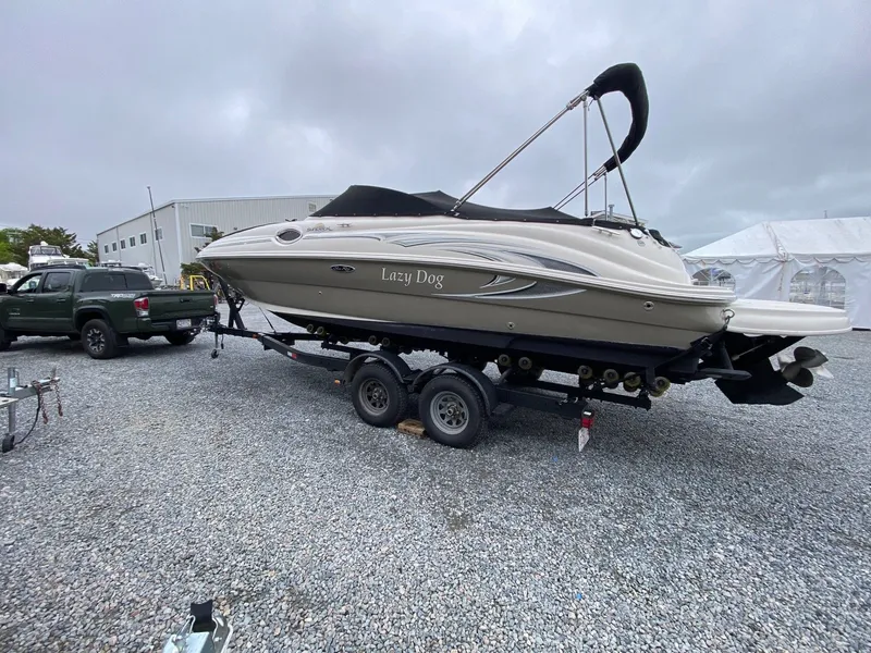 Slide: The Image of 2006 Sea Ray 240 Sundeck boat on trailer outdoors. - 2