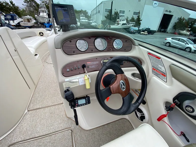 Slide: The Image of Interior view of 2006 Sea Ray 240 Sundeck cockpit with controls. - 4