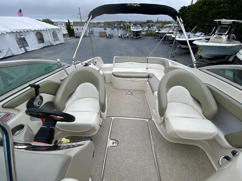 Slide: The Image of Interior view of a 2006 Sea Ray 240 Sundeck boat at the marina. - 9