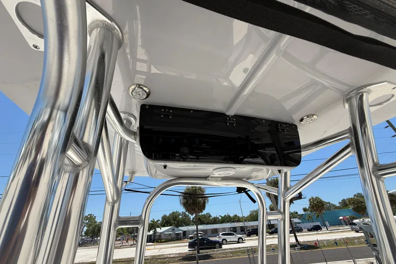 Slide: The Image of 2024 Key West 230 Bay Reef boat's T-top structure with polished metal supports. - 13