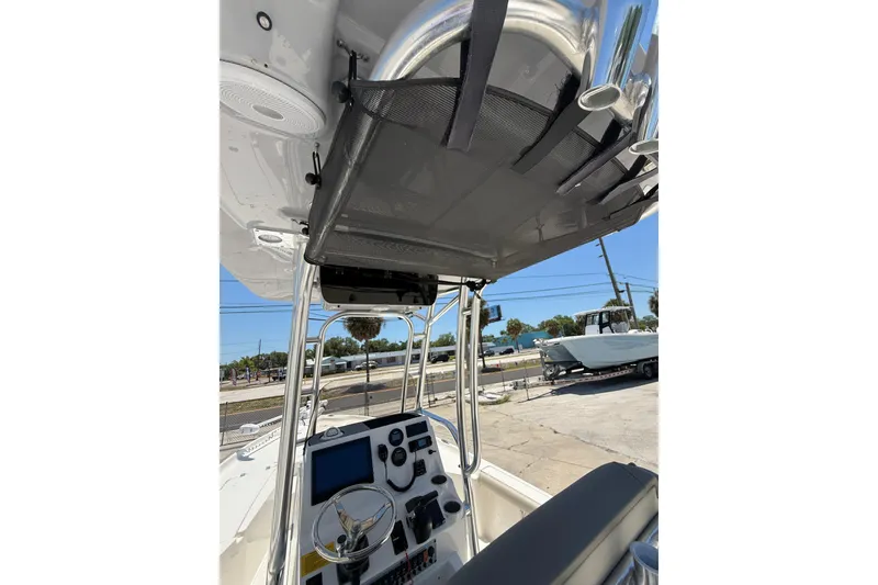 Slide: The Image of 2024 Key West 230 Bay Reef boat interior with steering console and overhead storage. - 14