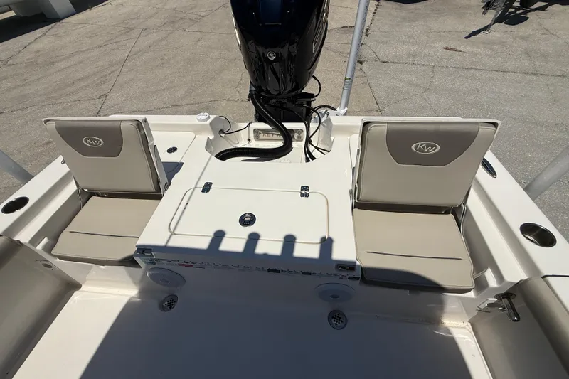 Slide: The Image of 2024 Key West 230 Bay Reef boat interior with seating and motor. - 15