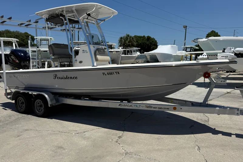 Slide: The Image of 2024 Key West 230 Bay Reef boat on trailer in sunny marina setting. - 5