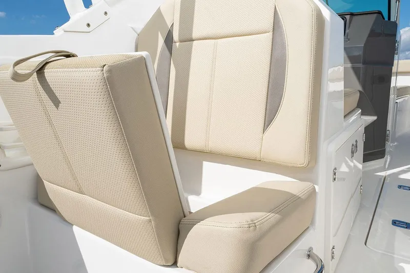 Slide: The Image of Manufacturer Provided Image: 2025 Pursuit DC 266 Dual Console boat seat, beige upholstery, modern design. - 10