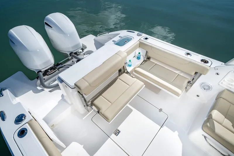 Slide: The Image of Manufacturer Provided Image: 2025 Pursuit DC 266 Dual Console boat interior with seating and twin engines. - 11