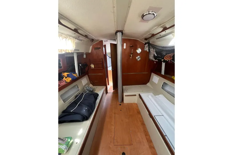 Slide: The Image of Interior of 1981 C&C 34 sailboat, featuring cozy cabin with wooden finishes. - 13