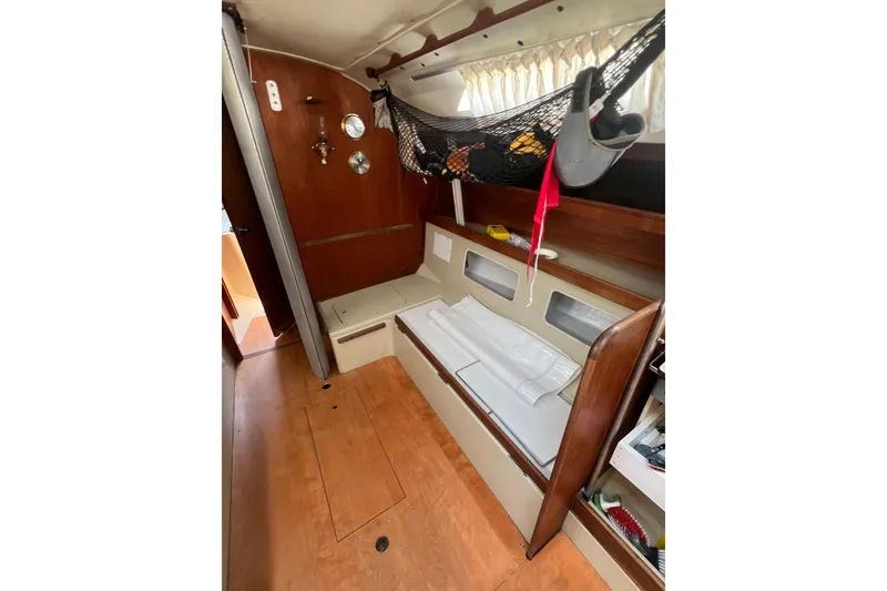 Slide: The Image of Interior of a 1981 C&C 34 sailboat with wooden finishes and storage hammock. - 15