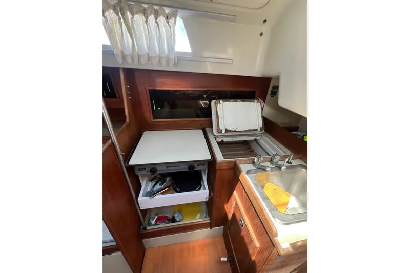 Slide: The Image of Interior of a 1981 C&C 34 sailboat galley with stove, sink, and storage. - 16
