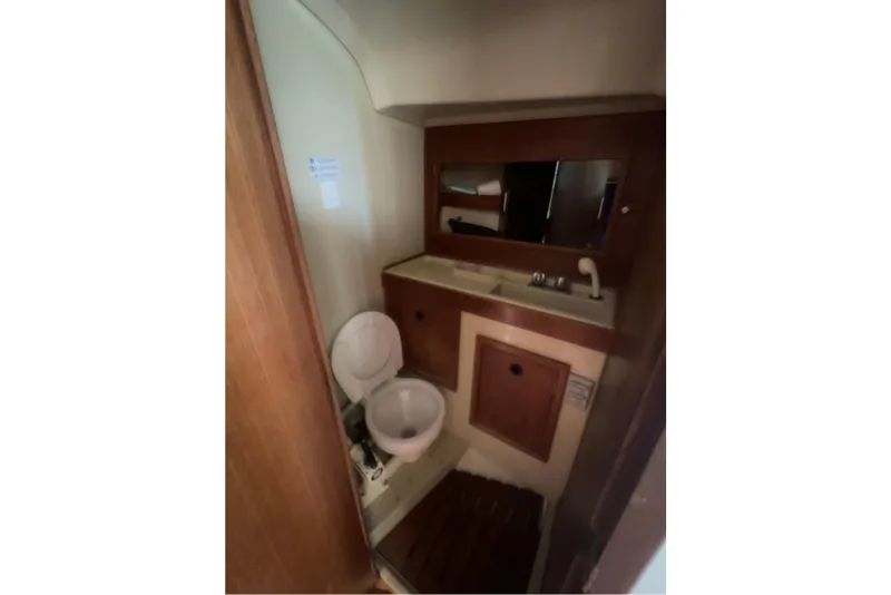 Slide: The Image of 1981 C&C 34 yacht bathroom with toilet, sink, and mirror. - 19