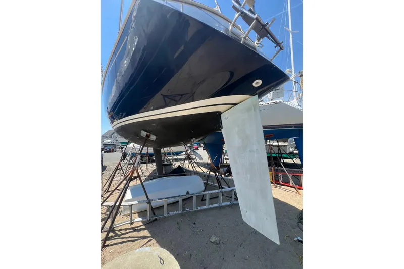 Slide: The Image of 1981 C&C 34 sailboat on stands, showing hull and keel in a boatyard. - 7