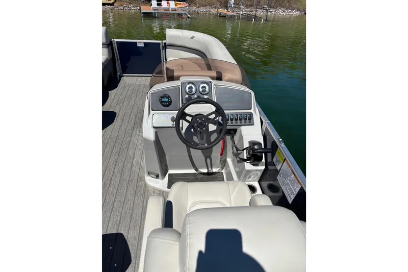 Slide: The Image of 2022 Starcraft EX 22 Q boat interior with steering wheel and control panel. - 10