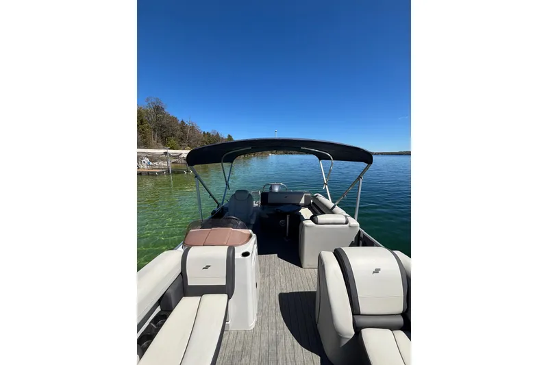 Slide: The Image of 2022 Starcraft EX 22 Q pontoon boat on clear lake under blue sky. - 7