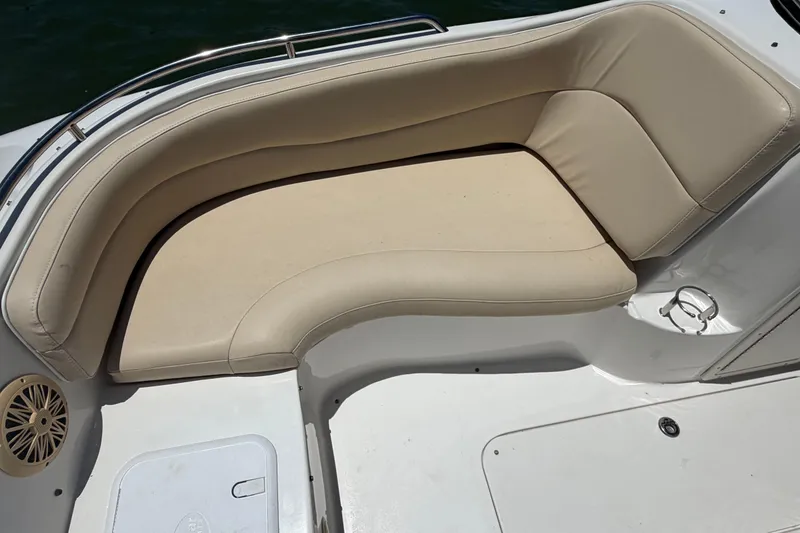 Slide: The Image of Beige seating on 2008 NauticStar 210 DC Sport Deck boat, featuring stainless steel railing. - 10