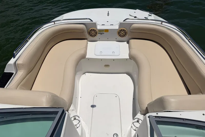 Slide: The Image of 2008 NauticStar 210 DC Sport Deck boat with beige seating and open deck layout. - 11