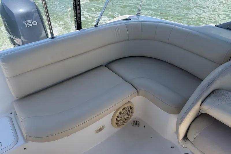 Slide: The Image of 2008 NauticStar 210 DC Sport Deck boat with beige seating and Yamaha 150 engine. - 15