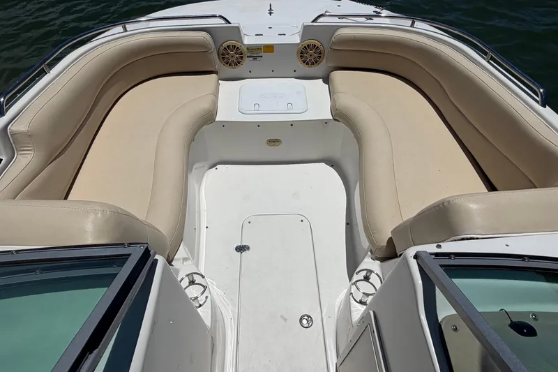 Slide: The Image of 2008 NauticStar 210 DC Sport Deck boat with beige seating and open deck layout. - 17