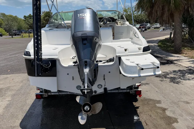 Slide: The Image of 2008 NauticStar 210 DC Sport Deck boat with 150 HP outboard motor, parked on trailer. - 18