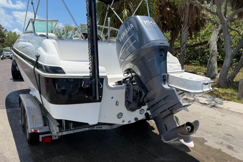 Slide: The Image of 2008 NauticStar 210 DC Sport Deck boat with Yamaha 150 engine on trailer. - 2