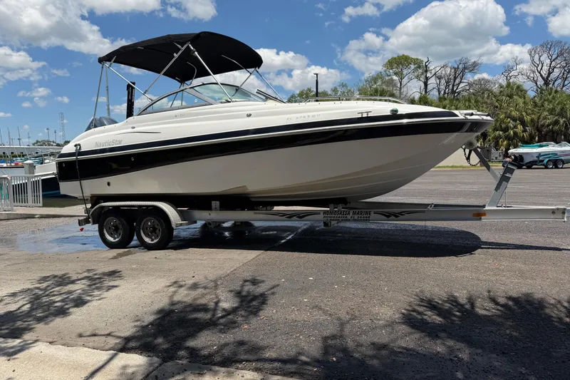 Slide: The Image of 2008 NauticStar 210 DC Sport Deck boat on trailer under blue sky. - 3