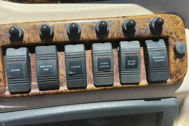 Slide: The Image of Control panel of a 2008 NauticStar 210 DC Sport Deck boat with labeled switches. - 7