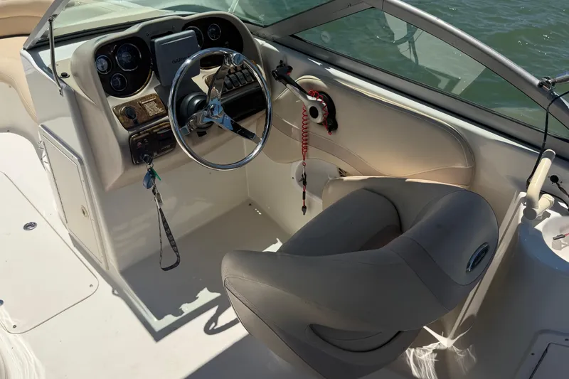 Slide: The Image of 2008 NauticStar 210 DC Sport Deck boat interior with steering wheel and dashboard controls. - 8