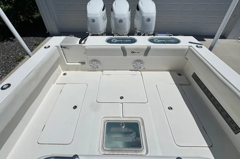 Slide: The Image of 2020 Sea-Lion 34 TE boat deck with triple outboard engines and storage compartments. - 11