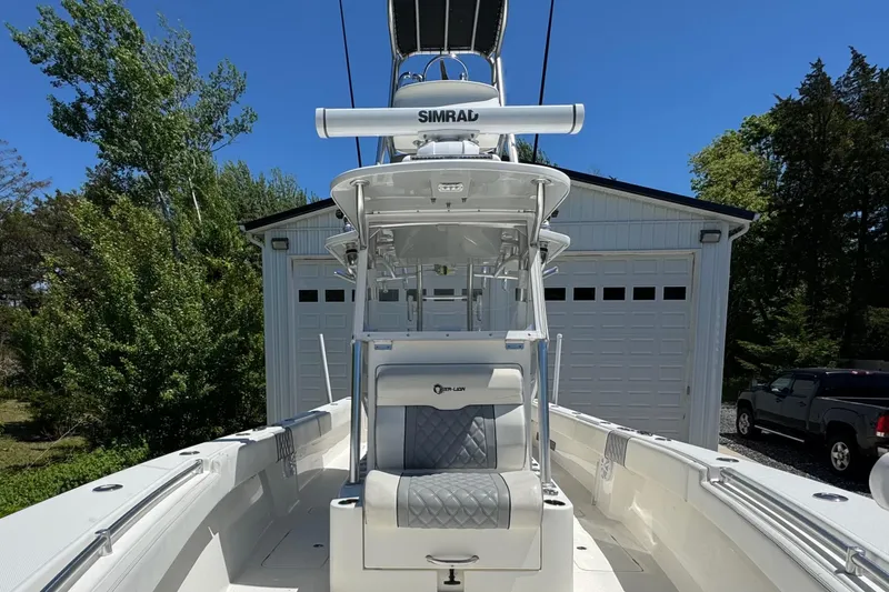 Slide: The Image of 2020 Sea-Lion 34 TE boat with Simrad equipment, parked near a garage. - 17