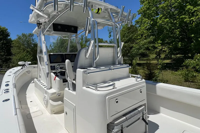 Slide: The Image of 2020 Sea-Lion 34 TE boat interior with helm, seating, and fishing rod holders. - 2