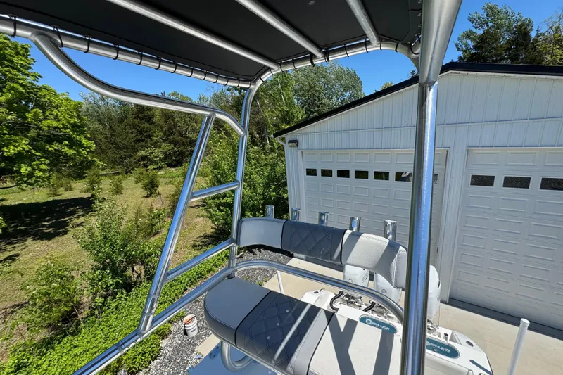 Slide: The Image of 2020 Sea-Lion 34 TE boat with T-top, parked near a white garage. - 25