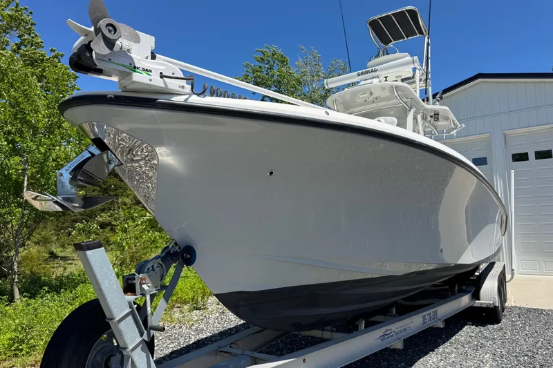 Slide: The Image of 2020 Sea-Lion 34 TE boat on trailer, parked near a garage under clear blue sky. - 26