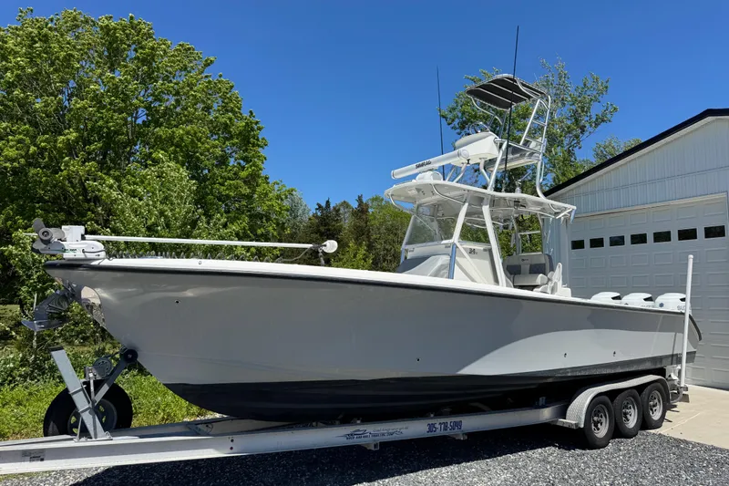 Slide: The Image of 2020 Sea-Lion 34 TE boat on trailer, parked near garage and trees. - 27