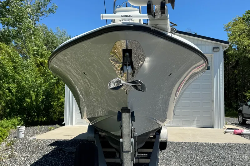 Slide: The Image of 2020 Sea-Lion 34 TE boat on trailer, parked near a garage, surrounded by trees. - 28