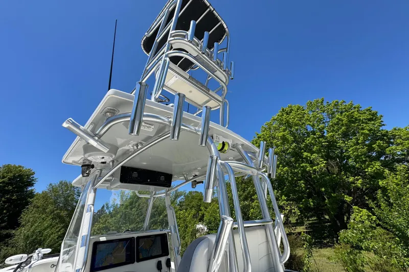 Slide: The Image of 2020 Sea-Lion 34 TE boat with tower against clear blue sky and green trees. - 3