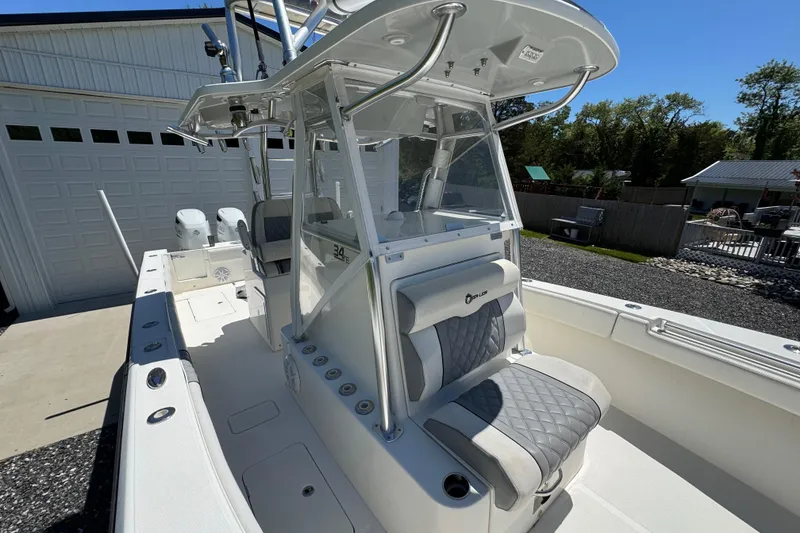 Slide: The Image of 2020 Sea-Lion 34 TE boat with sleek design, parked near a garage. - 4