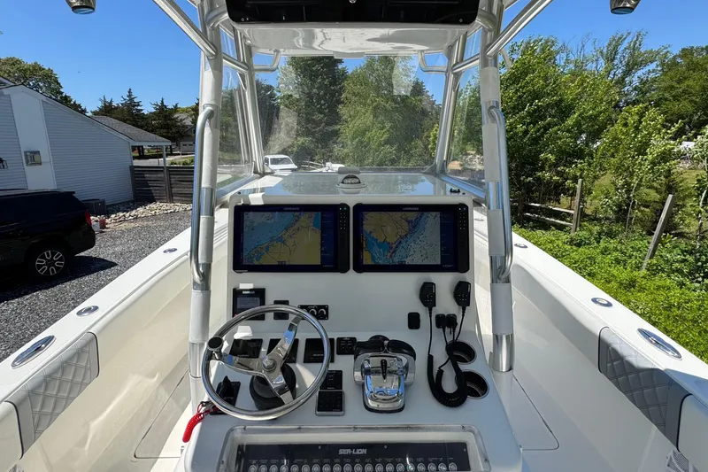 Slide: The Image of 2020 Sea-Lion 34 TE boat dashboard with navigation screens and steering wheel. - 5