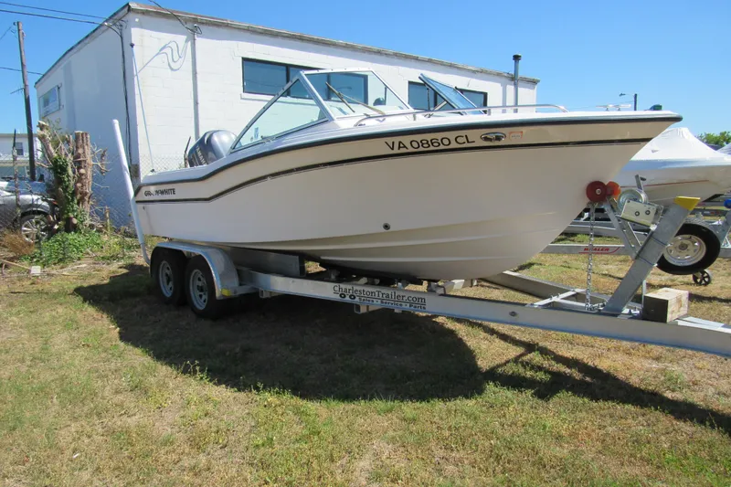 Slide: The Image of 2003 Grady-White Freedom 192 boat on trailer, parked outdoors near a building. - 1