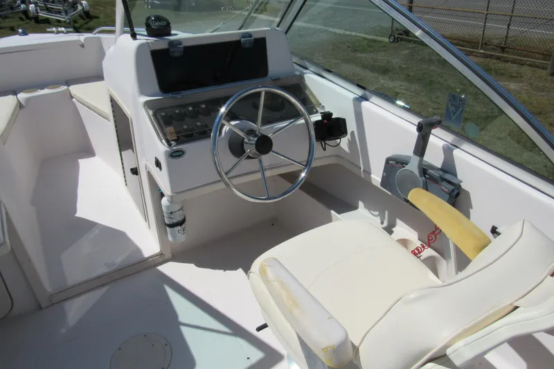 Slide: The Image of 2003 Grady-White Freedom 192 boat cockpit with steering wheel and control panel. - 13