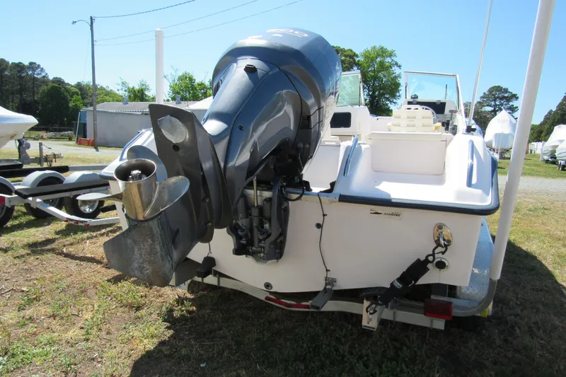 Slide: The Image of 2003 Grady-White Freedom 192 boat with outboard motor, parked on a trailer. - 6