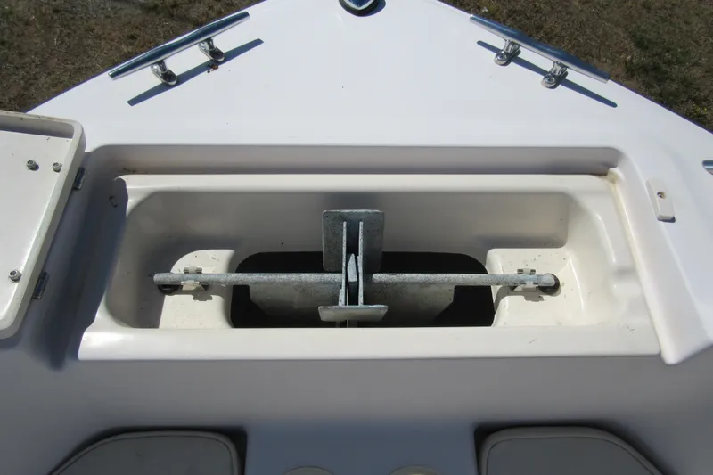 Slide: The Image of Anchor compartment of 2003 Grady-White Freedom 192 boat, featuring a neatly stored anchor. - 8