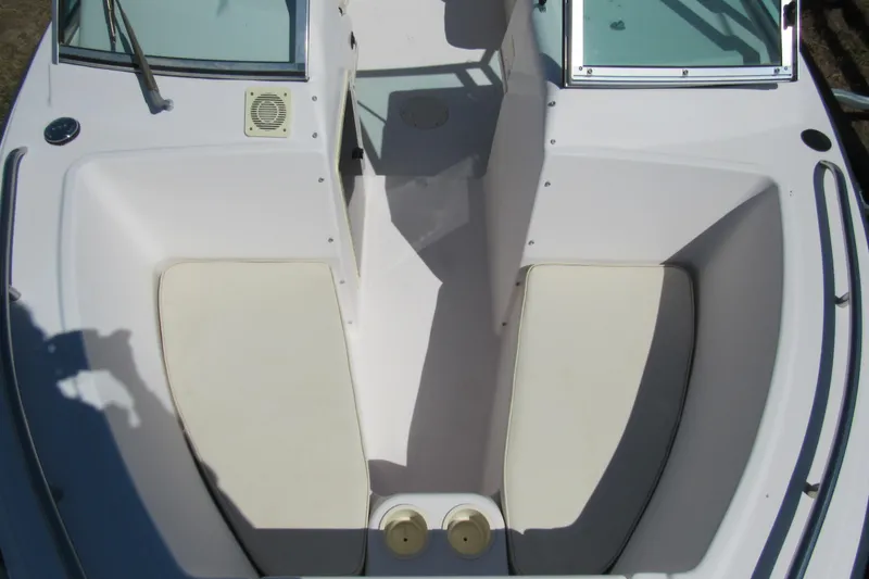 Slide: The Image of 2003 Grady-White Freedom 192 boat interior with cushioned seating and windshield. - 9