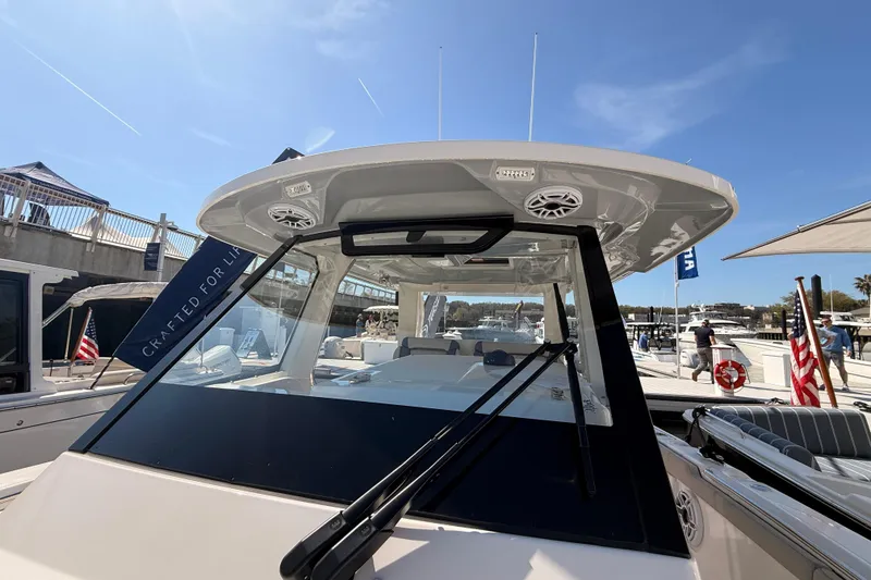 Slide: The Image of 2026 Pursuit S 328 Sport boat at marina, showcasing sleek design and modern features. - 21