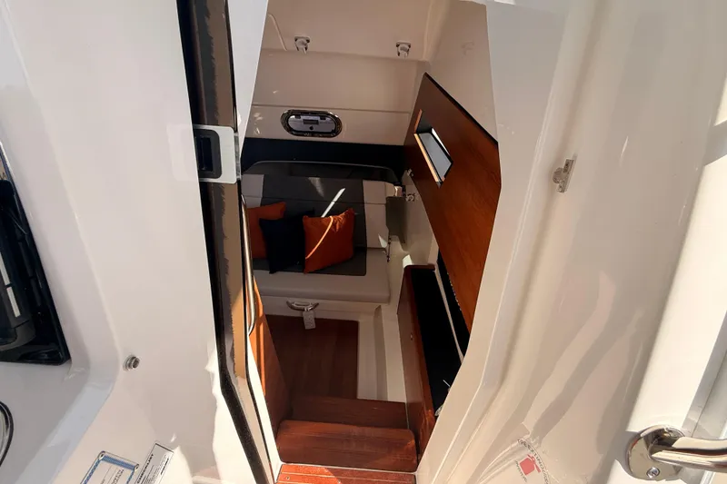Slide: The Image of Interior cabin of 2026 Pursuit S 328 Sport boat with seating and cushions. - 26