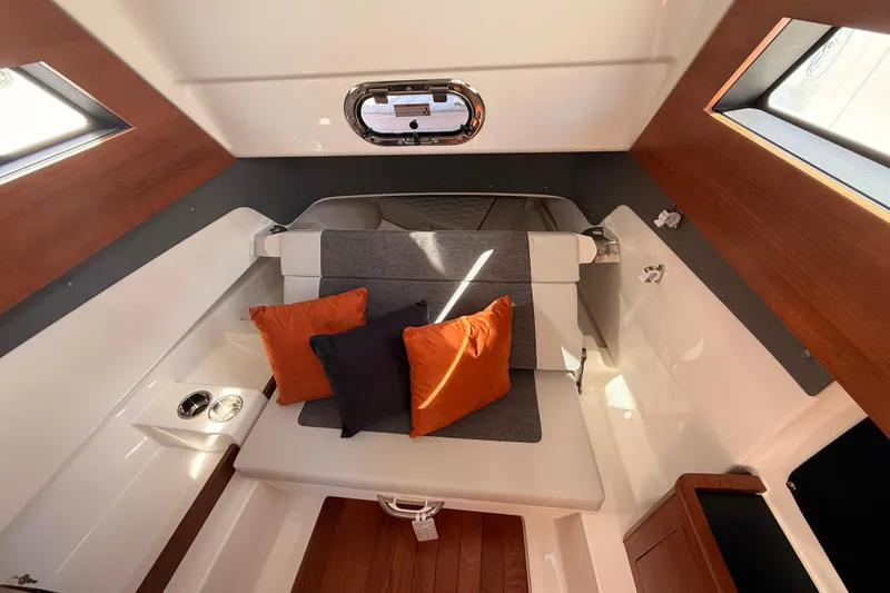 Slide: The Image of Interior of 2026 Pursuit S 328 Sport boat with cozy seating and vibrant cushions. - 28
