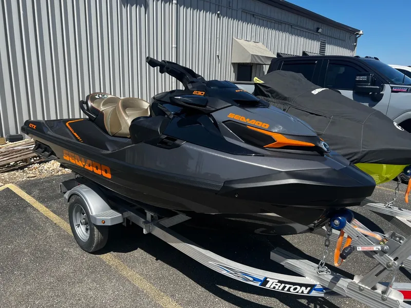 The Image of 2023 Sea-Doo GTX 230 jet ski on trailer, gray and orange. - 1