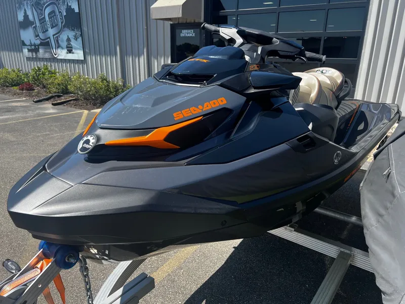 Slide: The Image of 2023 Sea-Doo GTX 230 jet ski with sound system, parked outside a building. - 2