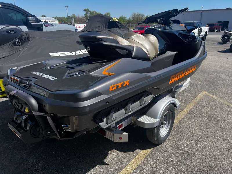 Slide: The Image of 2023 Sea-Doo GTX 230 jet ski parked on a trailer outdoors. - 3