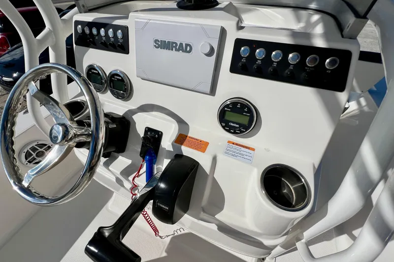 Slide: The Image of 2024 Robalo 206 Cayman boat dashboard with Simrad display and Yamaha controls. - 14