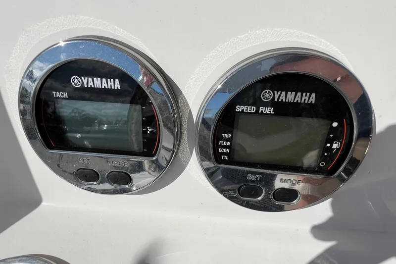 Slide: The Image of Yamaha tachometer and speed fuel gauges on 2024 Robalo 206 Cayman boat dashboard. - 18